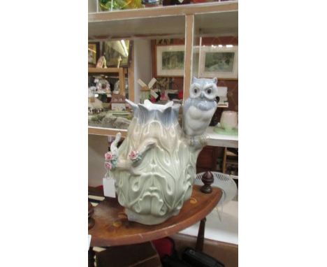 A ceramic vase with an owl handle,.