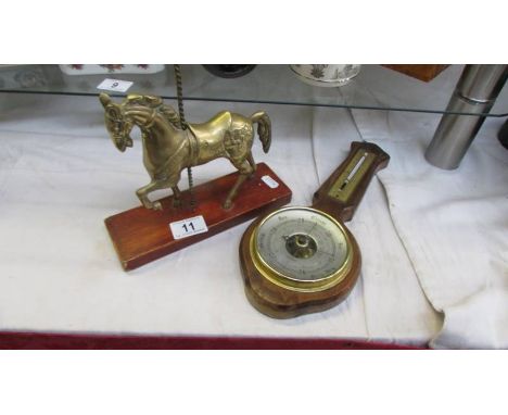 A brass carousel horse and a barometer.