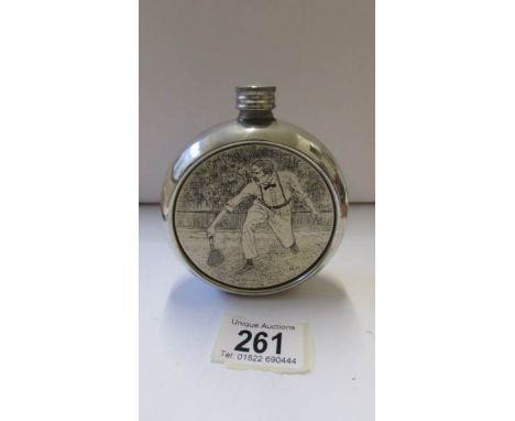 A silver plate hip flask depicting a tennis player.