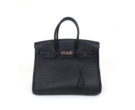 A HERMES 2010 BLACK BIRKIN 35 HANDBAG the pebbled leather exterior with dual rolled handles, top flap and strap closure, poli