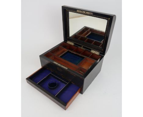 A MID-VICTORIAN COROMANDEL TRAVELLING TOILET BOX With fitted interior, including button-operated velvet and silk-lined concea