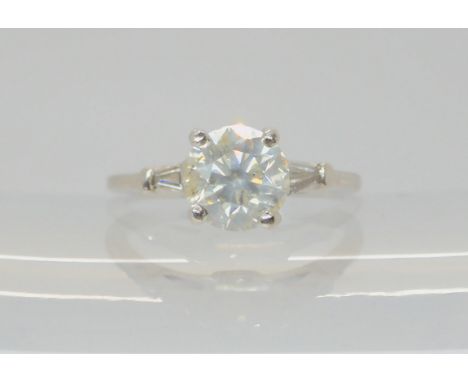 A DIAMOND SOLITAIRE RING the classic diamond solitaire, is estimated approx 1.98cts, with further baguette diamonds to the&nb