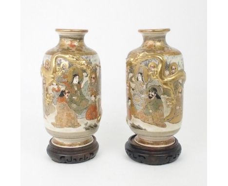 A PAIR OF SATSUMA VASES&nbsp; Each applied with moulded gilt dragons, enclosing Kannon and Sennin within stylised foliate ban