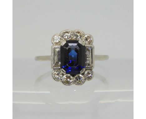 A SAPPHIRE &amp; DIAMOND RING set throughout in platinum, with a step cut sapphire of approximate dimensions 8.6mm&nbsp; x 6.