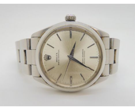 A ROLEX OYSTER PERPETUAL with stainless steel case and strap (78350). Silvered dial with silver coloured baton numerals and h