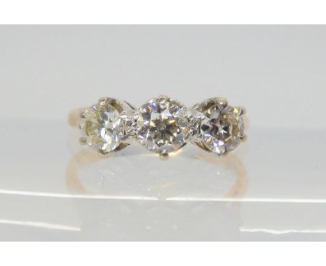 A THREE STONE DIAMOND RING with traditional yellow and white metal mount, set with estimated approx 0.85cts of old cut diamon