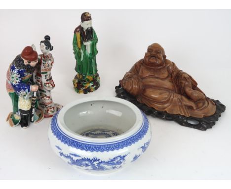 AN ARITA MODEL OF A WARRIOR AND GEISHA  She slapping his face and he grimacing, 25cm high, a Chinese official mottled green w