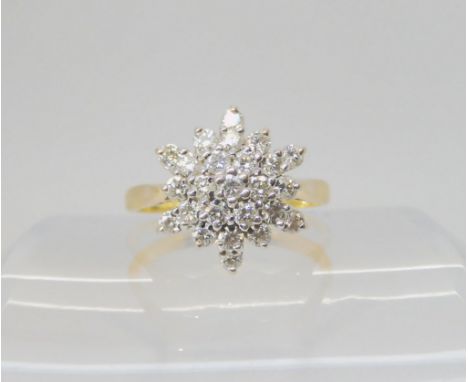 A DIAMOND SNOWFLAKE RING mounted throughout in 18ct yellow and white gold, set with estimated approx 0.75ct of brilliant cut 