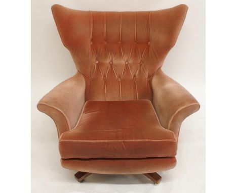 A MID 20TH CENTURY G PLAN MODEL 6250 SWIVEL WING BACK ARMCHAIR with pick velour button back upholstery on teak swivel base, 9
