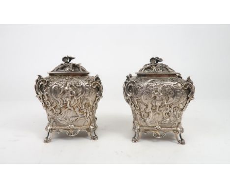 A PAIR OF WILLIAM IV SILVER CHINOSERIE TEA CADDIES of bombe form, profusely chased with rococo scrollwork surrounding vignett