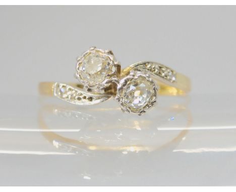 A TWIN STONE DIAMOND RING the bright yellow and white metal mount is set with two old cut diamonds, with an estimated approxi