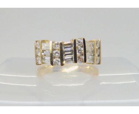 A 14K GOLD DIAMOND DRESS RING set with estimated approx 1.38cts of brilliant and baguette cut diamonds, finger size Q, weight