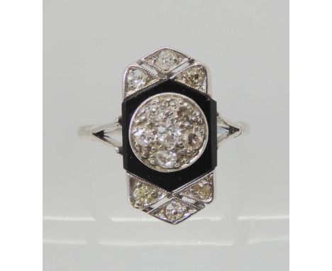 AN OLD CUT DIAMOND AND ONYX RING the white metal mount is set with estimated approx 0.40cts of old cut diamonds, with a centr