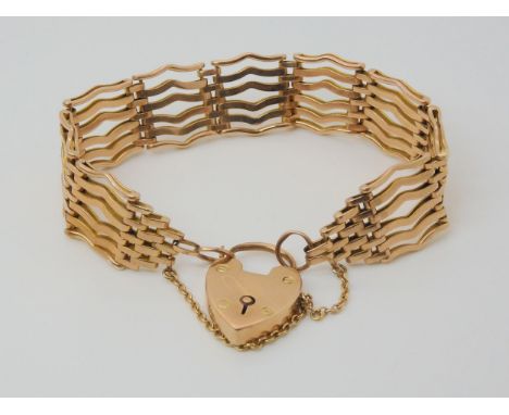 A 9CT ROSE GOLD GATE BRACELET with wave shaped links and a heart shaped clasp, length approx 19.5cm, weight 29.1gms Condition