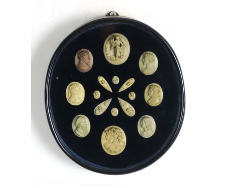 A FRAMED COLLECTION OF LAVA CAMEOS  The ebonised oval frame measuring approx. 23cm x 20cm Condition Report:Cameos overall are