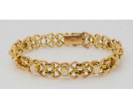 A 15CT GOLD OPAL BRACELET each knot shaped link set with an opal (four missing) length 18.2cm, weight 23.1gms Condition Repor