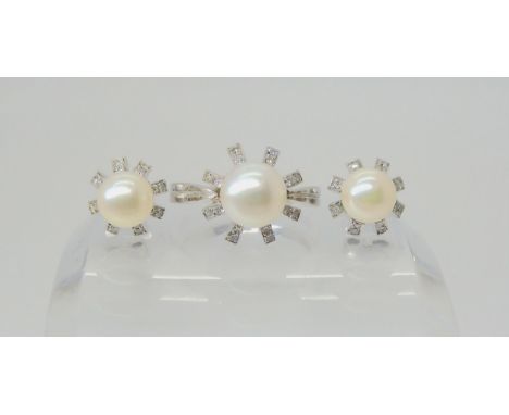 A STARBURST PEARL AND DIAMOND RING mounted in 14k white gold, set with a 8.4mm white pearl and set with 0.12cts of eight cut 
