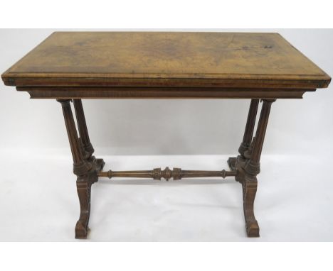 A VICTORIAN BURR WALNUT FOLD-OVER CARD TABLE with rectangular quarter-veneered top concealing shaped red baize playing surfac