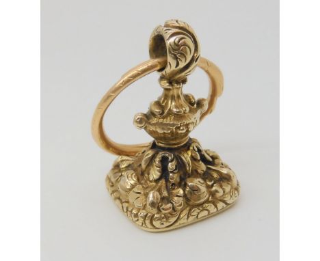 A DECORATIVE YELLOW METAL FOB SEAL the bloodstone face intaglio carved, with a griffin and family crest, the body of the seal