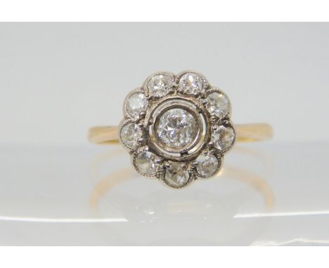 A DIAMOND FLOWER RING the bright yellow metal mount is set with estimated approx 0.40cts, of old cut diamonds, finger size M,