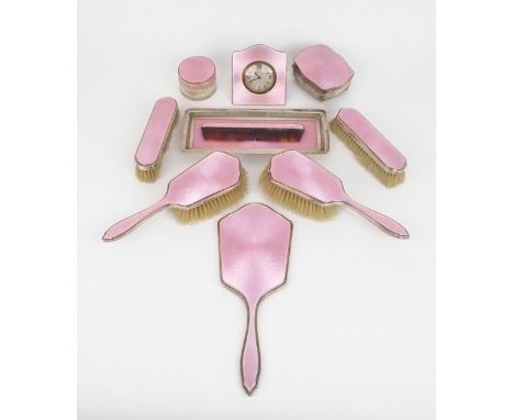 A GEORGE V TEN PIECE SILVER AND GUILLOCHE ENAMEL DRESSING SET comprising two clothes brushes, two hair brushes, a comb, powde