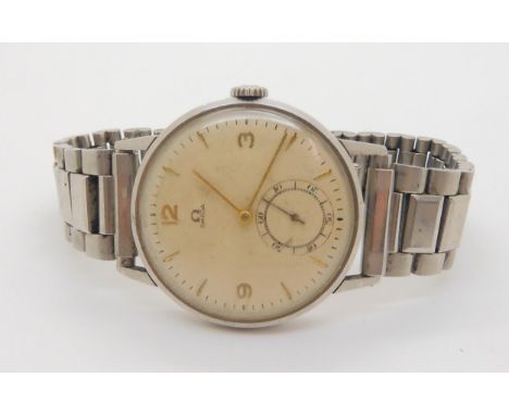 A GENTS VINTAGE OMEGA with stainless steel case & strap, cream dial, gold coloured Arabic and chevron numerals and hands, wit