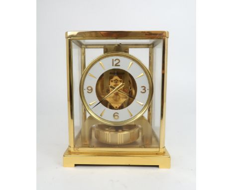 A JAEGER LE COULTRE ATMOS CLOCK in glazed brass case, the white enamel chapter ring with applied batons and Arabic numerals a