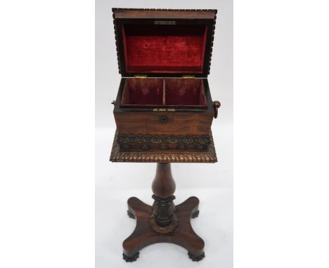 A VICTORIAN ROSEWOOD TEAPOY with sarcophagus moulded hinged top caddy on turned pedestal on quatrefoil base terminating in ca