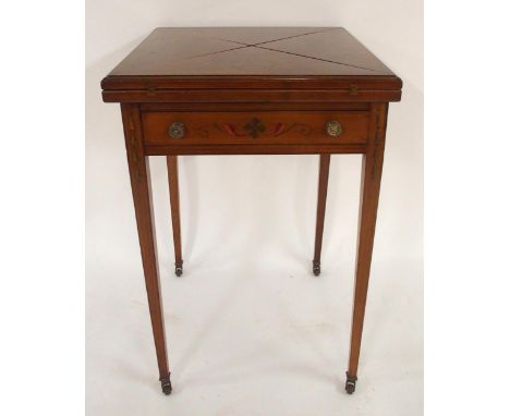 AN EDWARDIAN MAHOGANY ENVELOPE CARD TABLE with each folding section painted with ribbons and wreathes and surrounded with che