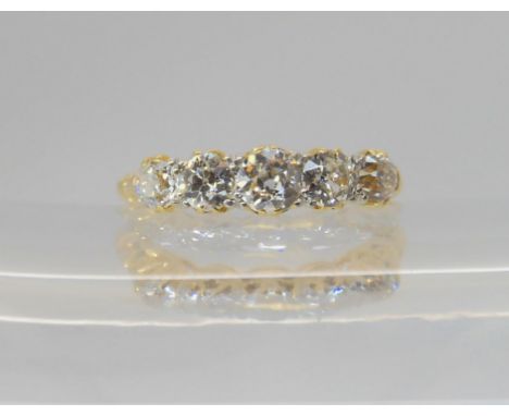 A FIVE STONE DIAMOND RING set with estimated approx 0.75cts of old cut diamonds, to a classic scroll mount, finger size P1/2,