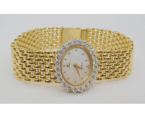 A 14K GOLD DIAMOND SET CYMA LADIES WATCH mother of pearl dial with gold dot numerals, set with estimated approx 1.44cts of br
