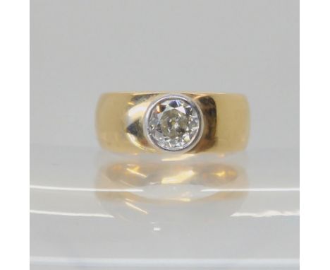 A DIAMOND SOLITAIRE the wide band ring is stamped 375 and has a bezel set diamond of estimated approx 0.70cts, finger size L,