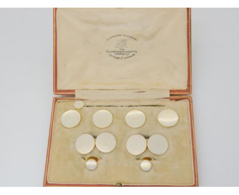 A BOXED SET OF 18CT LINKS &amp; STUDS retailed by The Goldsmiths &amp; Silversmiths Company, Regents St, London. Decorated wi