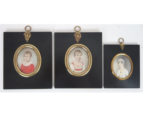 THREE REGENCY PORTRAIT MINIATURES PAINTED ON IVORY In ebonised frames, comprising a lady with ringleted hair and lace bonnet;