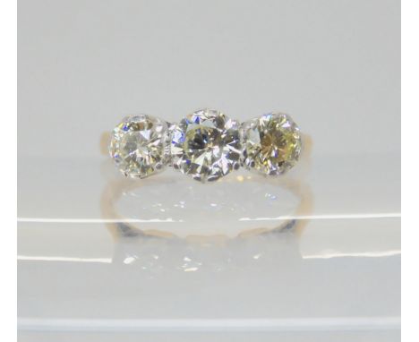 A THREE STONE DIAMOND RING the 18ct and platinum shank is set with estimated approx 1ct of brilliant cut diamonds. finger siz