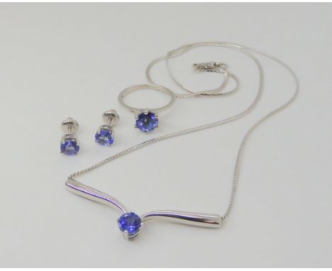A 9CT WHITE GOLD TAZANITE SUITE comprising of a 9ct white gold ring with six prong setting, finger size K, a 9ct white gold n