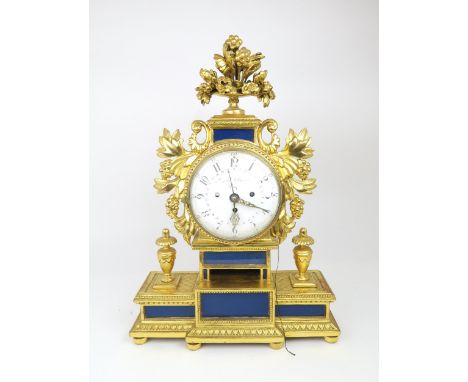 A LEOPOLD SCHMIDT PRAG GILTWOOD CHIMING MANTLE CLOCK the circular white enamel face with concentric date ring with steel poin