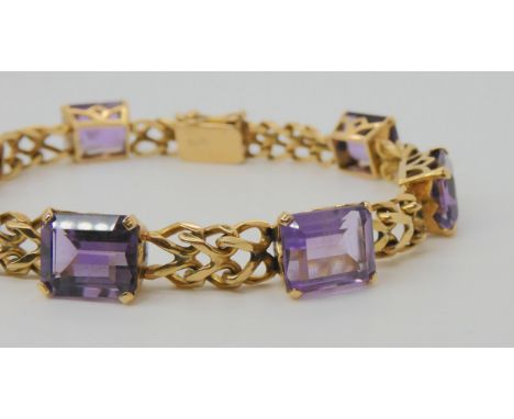 A FANCY LINK AMETHYST BRACELET the box clasp stamped 18k, and set with seven step cut amethysts with the approximate dimensio