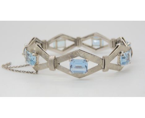 A RETRO WHITE METAL AQUAMARINE BRACELET the galleried diamond shaped links with all over crosshatched texture, and each set w