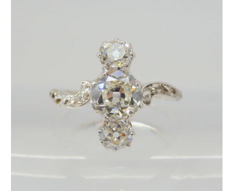 A VINTAGE THREE STONE DIAMOND RING the central old cut is estimated approximately at 0.95cts, with the two cushion cut diamon