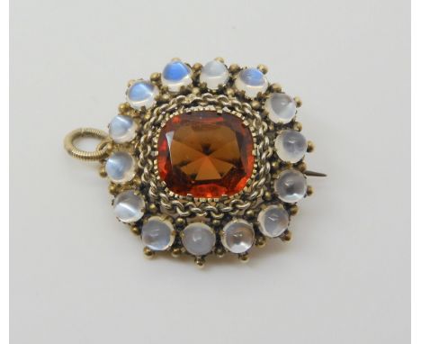 A HESSONITE GARNET &amp; MOONSTONE PENDANT the orange garnet is st in a white metal chain link setting, and surrounded with a