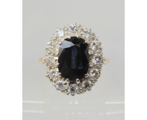 A SAPPHIRE &amp; DIAMOND RING the classic cluster is set with a sapphire which measures approx 11mm x 7.8mm x 4.8mm, surround