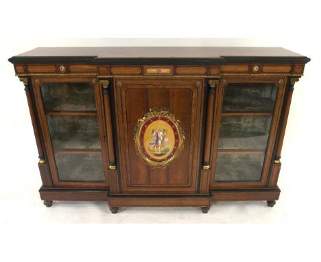 A VICTORIAN WALNUT AND EBONISED BREAKFRONT CREDENZA&nbsp; with ormolu mounts, four columns with a pair of glazed doors flanki