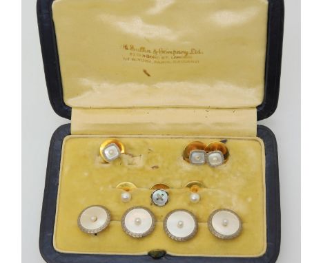 A BOXED SET OF BUTTONS &amp; STUDS Four 18ct gold and white metal mother of pearl and pearl set buttons, together with three 