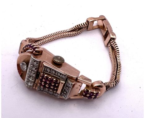 An American Art Deco 14K yellow gold ruby and diamond cocktail with with sprung hidden face set with approximately 1.13ct dia
