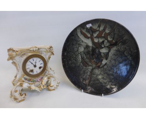 A Chinese studio pottery charger and a French ceramic cased mantel clock.