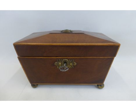 A Regency mahogany tea caddy, the rising lid to two compartments.