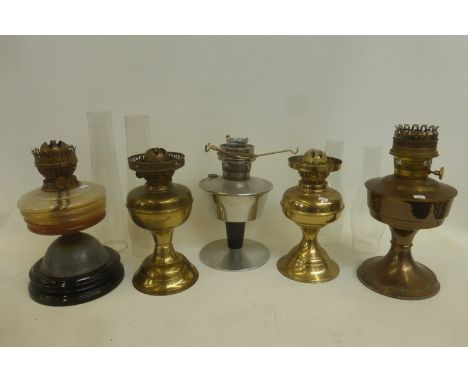 An assortment of oil lamp bases with reservoirs and four glass funnels.