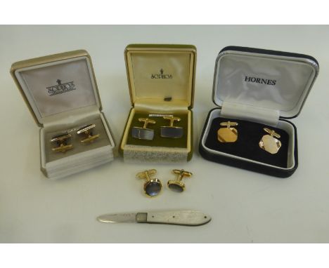 A silver mother of pearl fruit knife and an assortment of cufflinks.