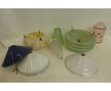 An assortment of glass and enamel lamp shades including 1950s.